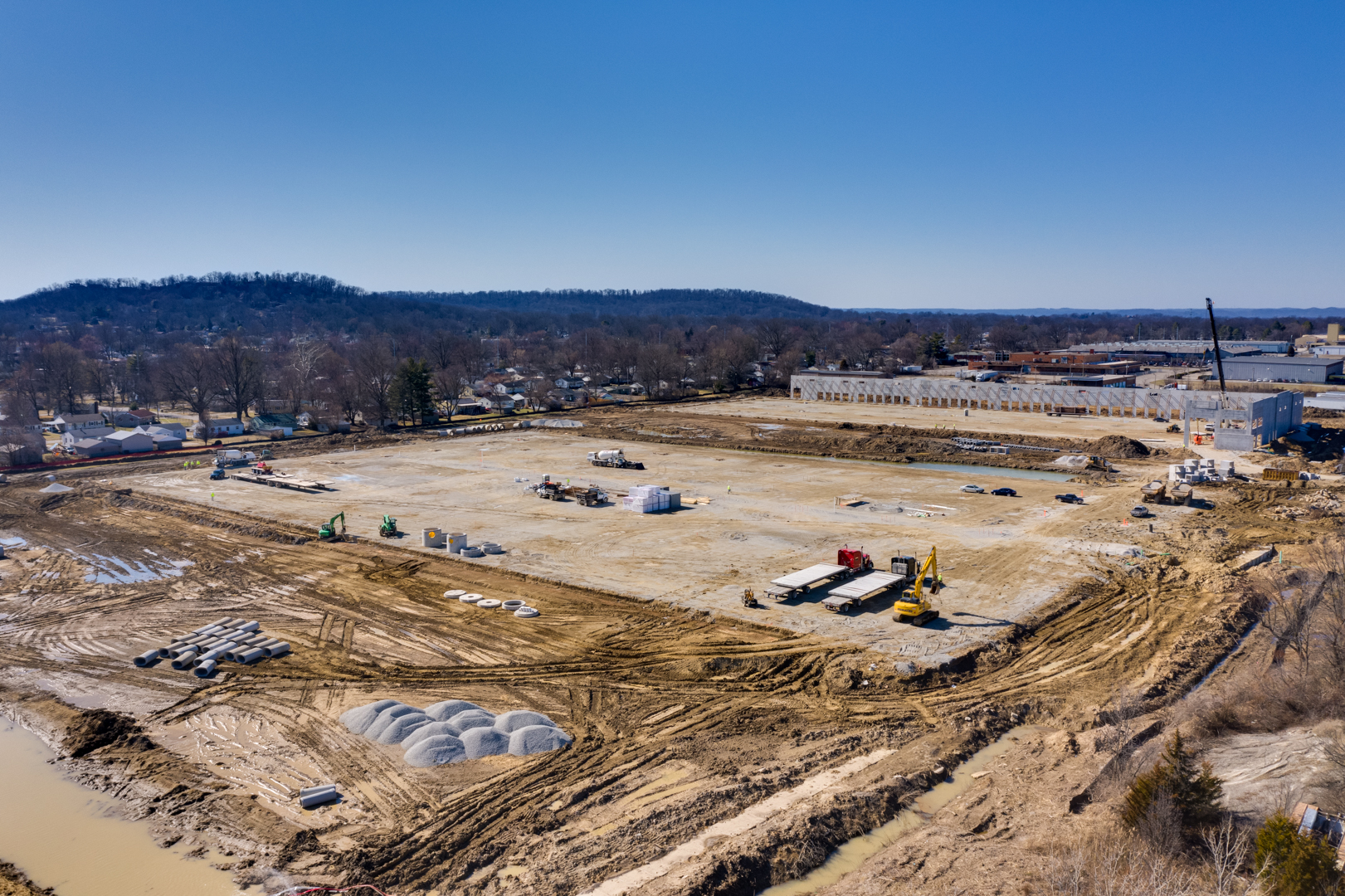 construction site with large empty building slab surrounded by office park.