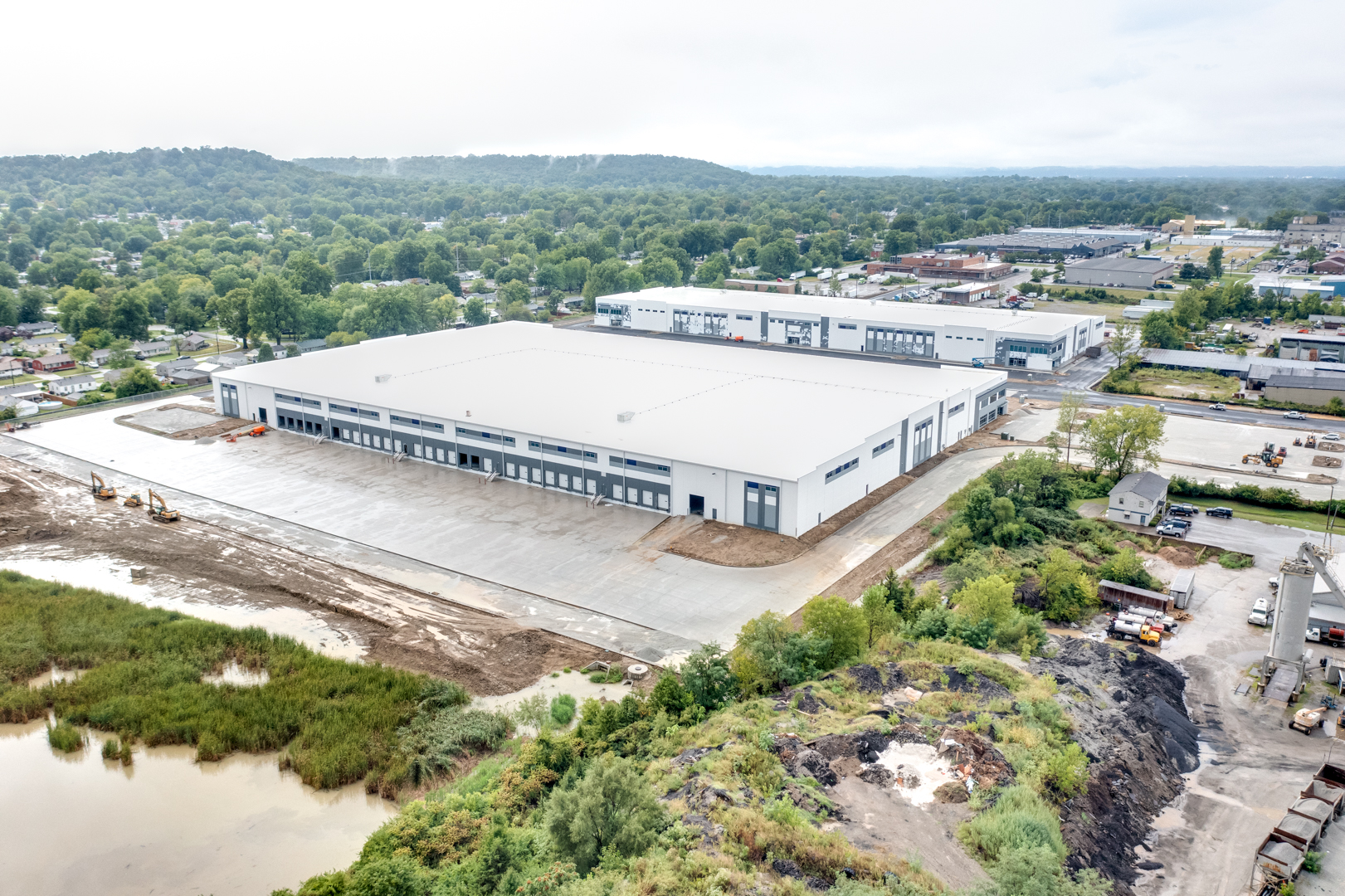 completed warehouse with blue and white exterior and new parking lot