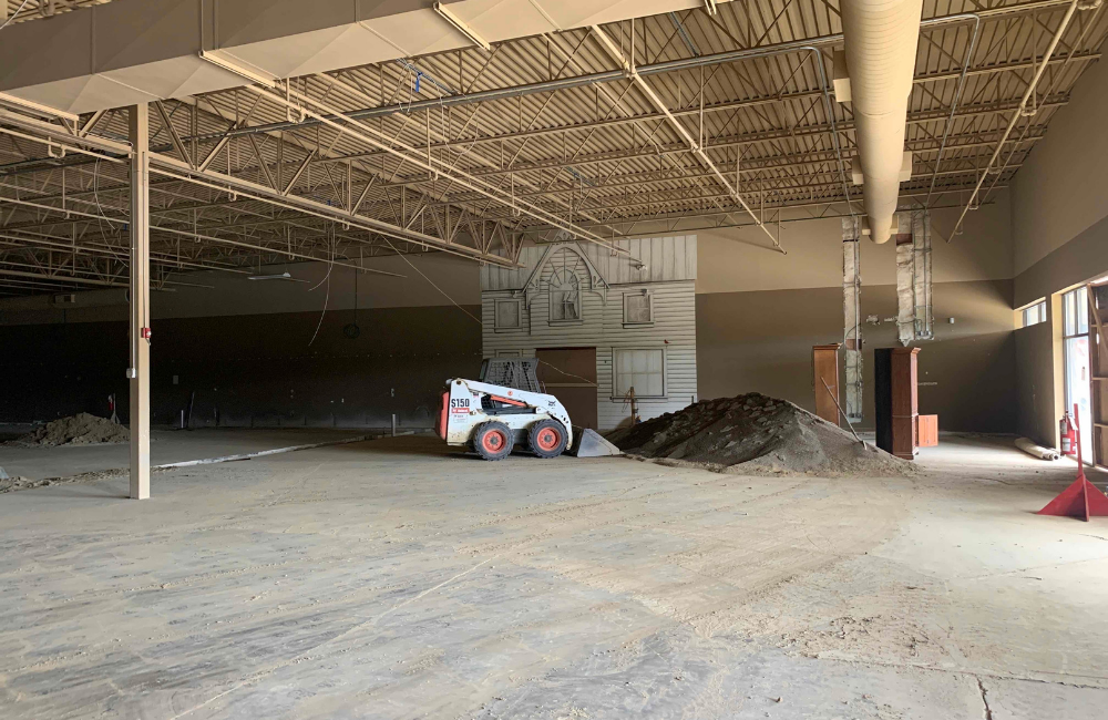 construction site with large empty building slab surrounded by office park.