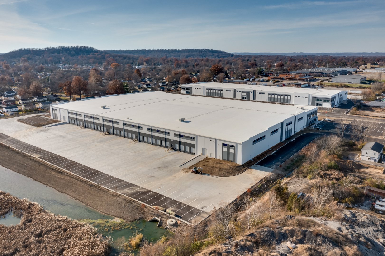 completed warehouse with blue and white exterior and new parking lot