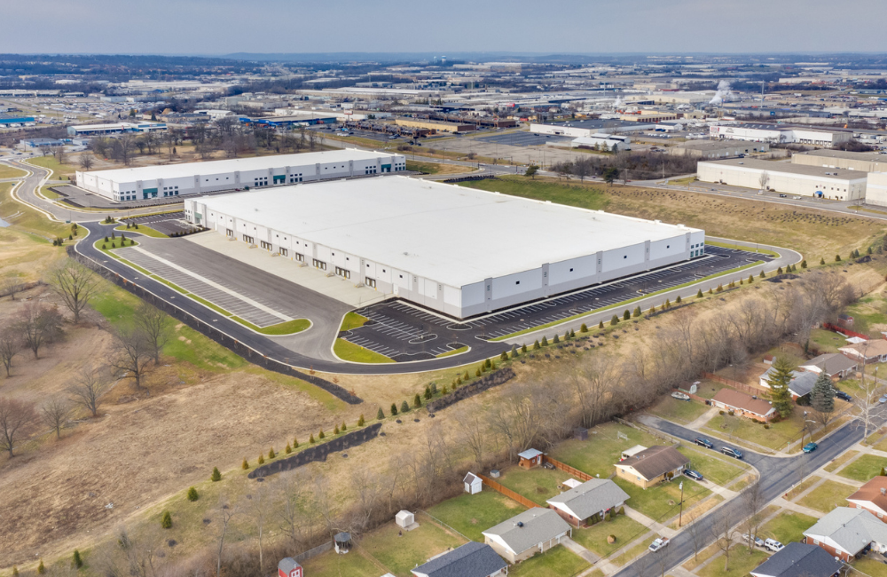 completed warehouse with blue and white exterior and new parking lot