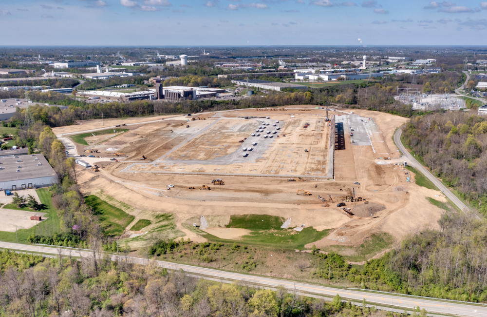 construction site with large empty building slab surrounded by office park.