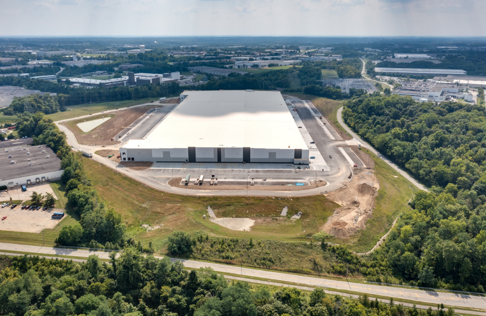 completed warehouse with blue and white exterior and new parking lot